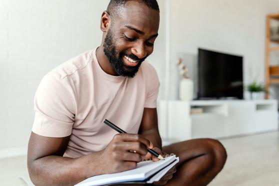 Man writing in a notebook